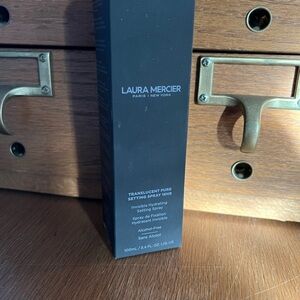 New Laura Mercier Setting Spray Packaging with Black and White Text